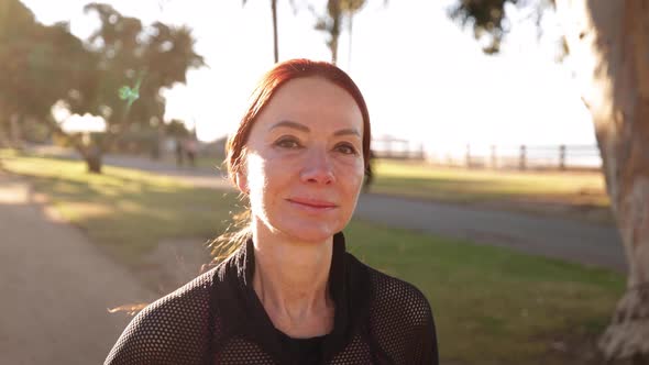 Mature Woman Exercising At The  Beach alt