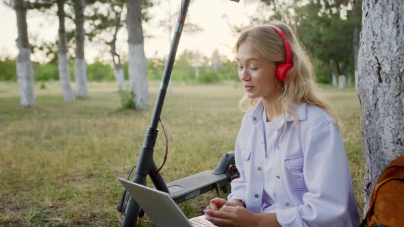 Handsome Young Woman with Blonde Hair in the Park alt