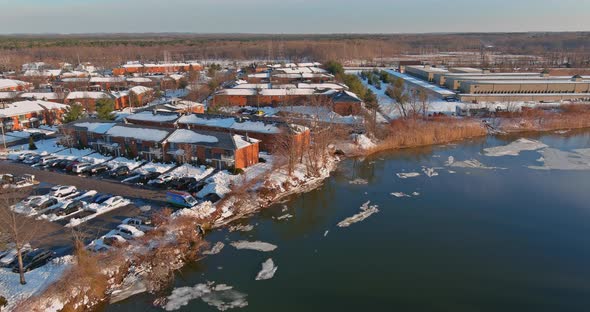 Ice drift on the river early spring ice float down the stream view apartment complex alt
