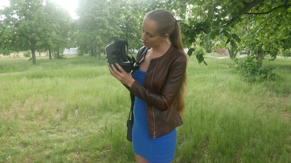 Sexy Girl Looks At The Virtual Reality Helmet In The Park
