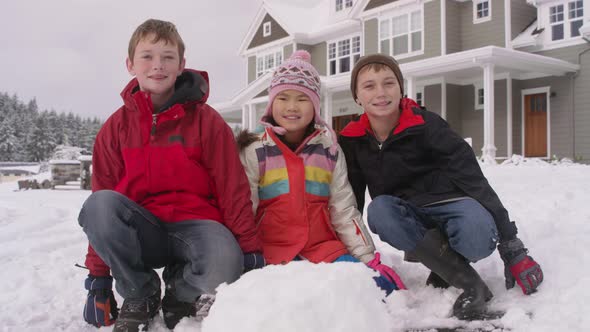 Portrait of three kids with snow in winter