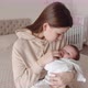 Caring Mother Lulls Baby In Her Arms - VideoHive Item for Sale