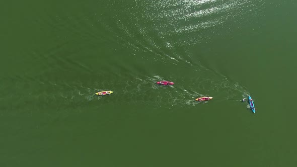 aerial top down of kayakers bypassing buoy during water competition alt