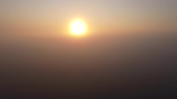 Immersion of a Drone in a Thick Fog at Sunrise alt