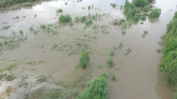 Overflow of water from river body from above 4K aerial video alt