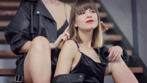 Happy Brunette Lesbian Woman with Brown Eyes Smiling As Unrecognizable Tattooed Partner Touching Her alt