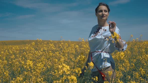 Ukrainian Woman in Ethnic Dress in the Field
