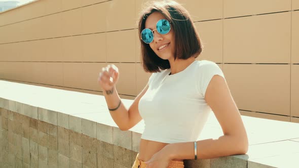 Young beautiful sexy smiling hipster woman posing outdoors alt