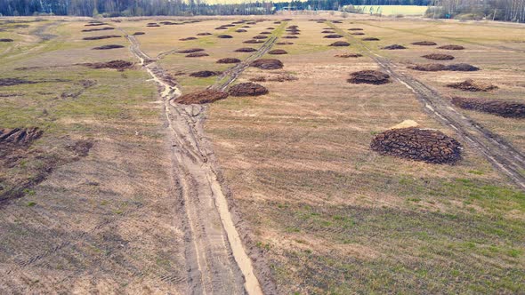 Round Heaps of Manure on an Agricultural Field Aerial View alt