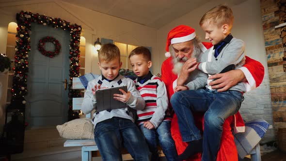 Little Boys  with Santa Claus Playing with Tablet