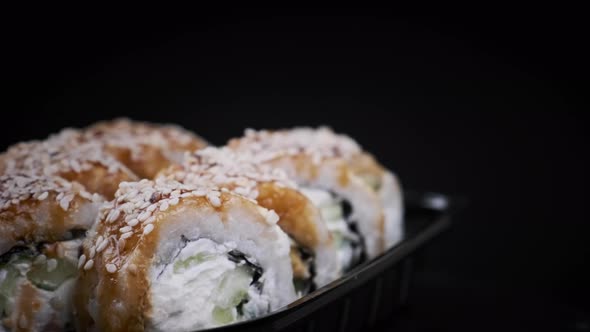 Sushi Rolls Rotating in Plastic Box alt