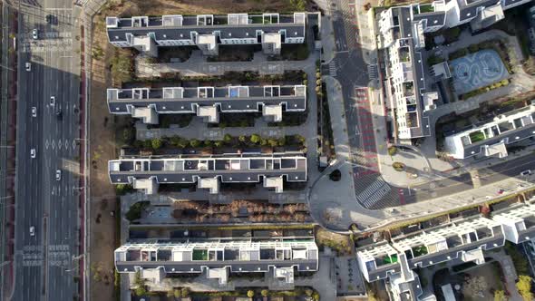 Small apartments standing in the morning. Their shadows makes the landscape watched over the sky bea alt