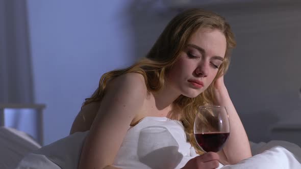 Lonely Woman Drinking Wine in Bed at Night, Alcohol Addiction, Depression alt