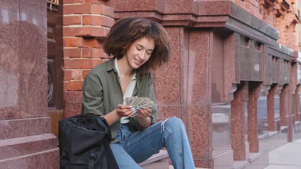 Pleased Black African American Woman Counting Dollar Banknotes alt