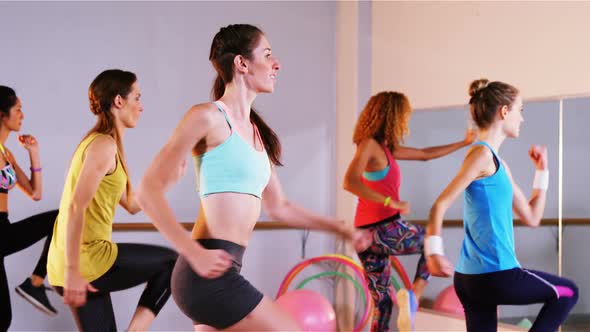 Woman smiling while performing aerobics exercise with the team alt