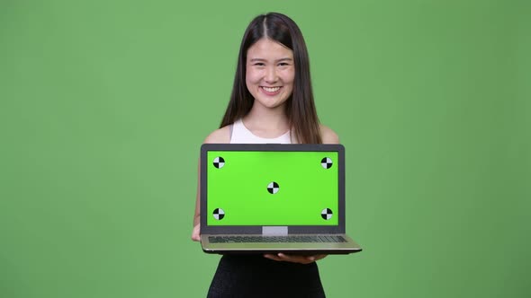 Young Beautiful Asian Businesswoman Showing Laptop