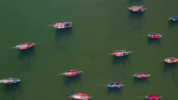 Many fishing boats on the coast beside the mountains, beautiful sea area in Thailand. alt