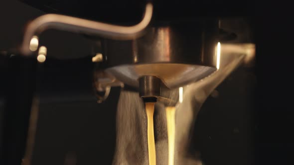 Pouring Coffee Stream From Professional Machine in Cup alt