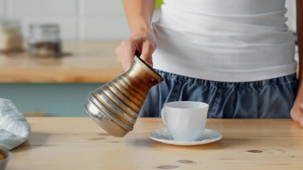 Slow Motion Of Pouring Coffee In Cup From Cezve