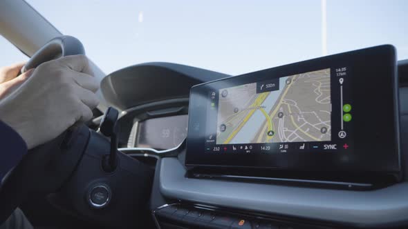 A Map and GPS on the Touchscreen System on the Dashboard in a Driven Car  Closeup