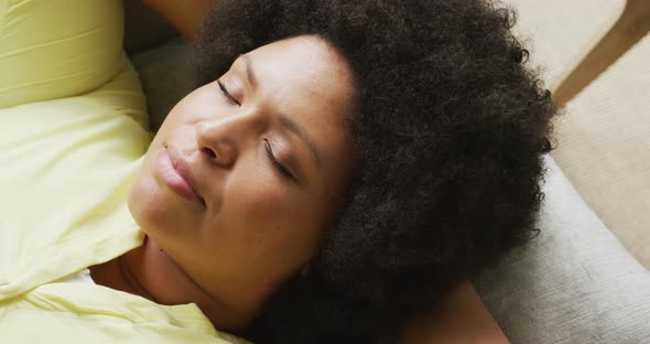 Video of plus size african american woman relaxing on sofa alt
