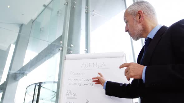 Businessman giving a presentation in a meeting alt