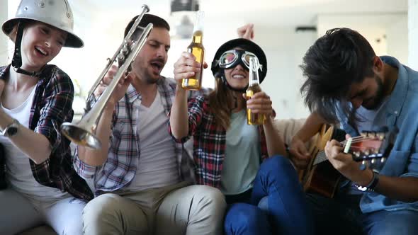 Cheerful Friends Having Party Together and Playing Instruments
