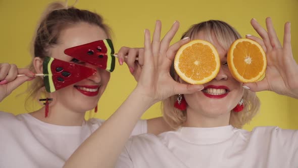 Happy Girls Having Party and Dancing on Yellow Background