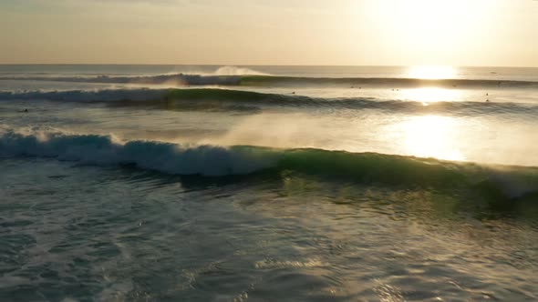 Following large waves at sunset