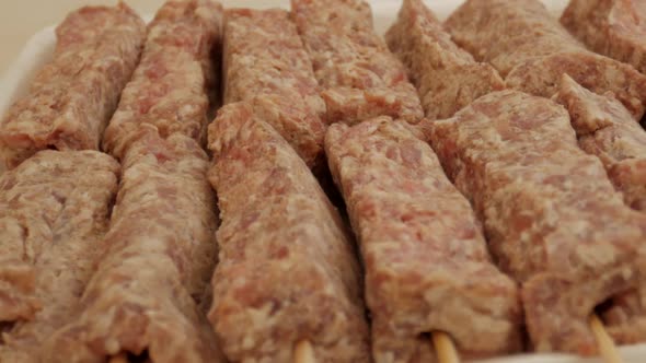 Mititei Made Of Ground Meat Rolls In Cylindrical Shape On Skewers. - close up slider alt