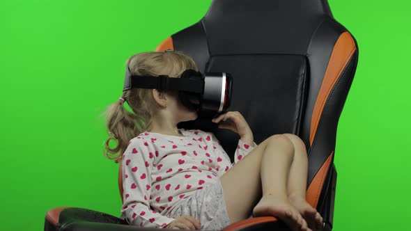 Child Girl Using VR Headset Helmet To Play Game. Watching Virtual Reality 3d 360 Video. Chroma Key alt