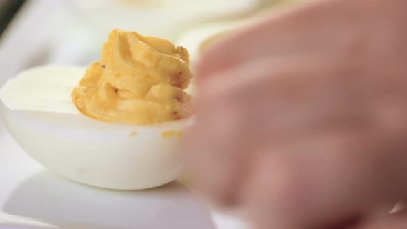 Preparing deviled eggs with organic eggs for appetizer. Step by step recipe. alt