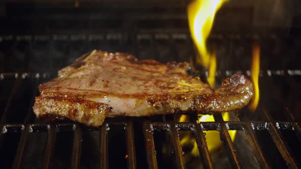 T-Bone Steak On Barbecue Grill Flames 44