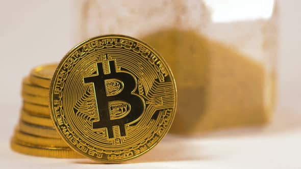 Closeup Bitcoin Real Model Stands Against Yellow Coin Pile alt