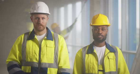 Portrait of Diverse Builders Posing at Camera at Construction Site alt