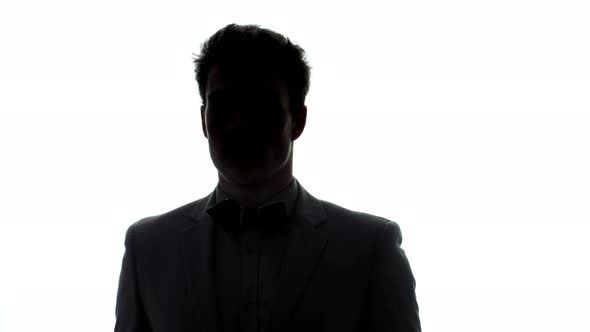 Well-Dressed Young Man with a Classic Bow Tie in Silhouette