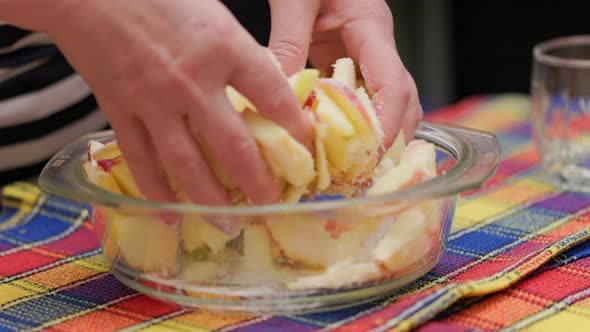 Senior Caucasian Woman Mixing Cut Apples with Sugar with Bare Hands for Apple Pie Filling Closeup