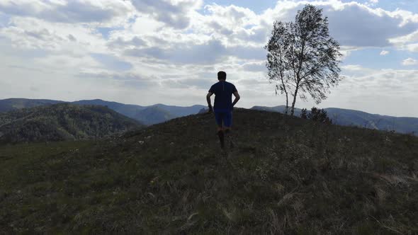 Athlete Running on a Mountain Trail. Skyrunner Trains Outdoors