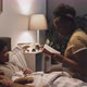 Woman Reading Book to Boy at Night - VideoHive Item for Sale
