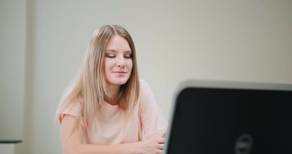 Concentrated Long Haired Blonde Listens to Online Lecture alt
