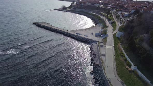 Aerial View of the City of Nessebar with Parks and Houses Built Up Streets with People Walking in alt