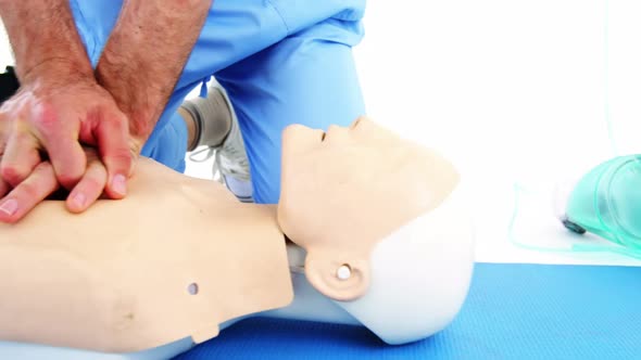 Male paramedic during cardiopulmonary resuscitation training alt