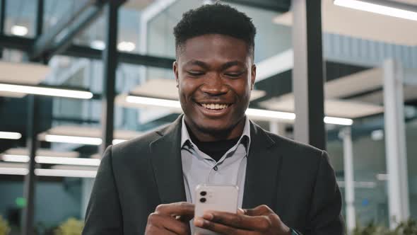 Supervisor African Man Office Manager Holding Smartphone in Male Hand Touching Screen Display alt