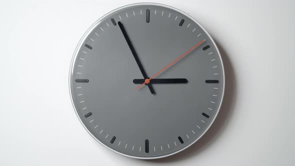 Clock Face Timelapse from 3 to 4 o'clock on white wall in office