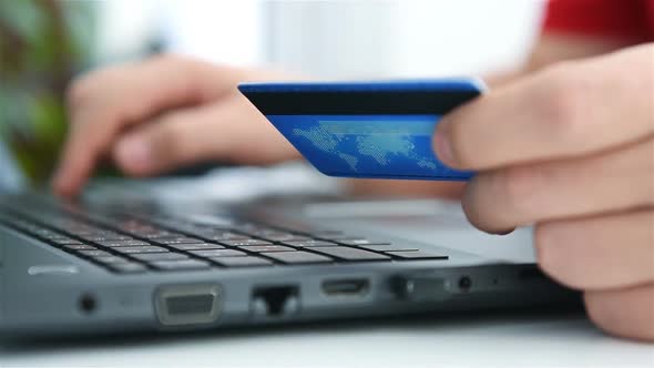 Businessman Enters Credit Card Details For Online Shopping.