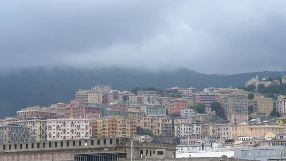 Housing blocks and apartments against hill side. Cloudy day. Genoa, Italy. alt