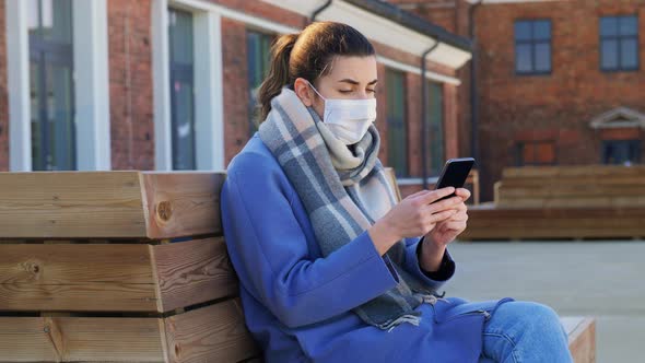 Woman in Face Mask with Smartphone in City alt