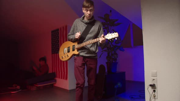 Energetic Young Man Playing Rock Music on Guitar