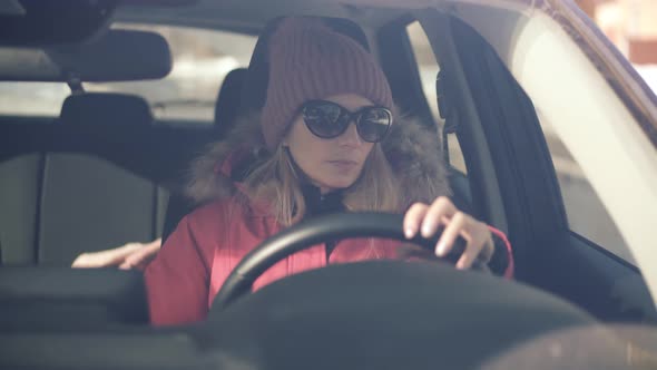 Drunken Driving Risk Car Accident.Man Holding Alcohol Bottle In Car. Dangerous On Road Drunk Driver. alt