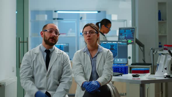 Team of Researchers Looking at Virtual Display with Touchscreen alt